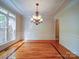 Dining room featuring hardwood floors, chandelier, wainscoting, and windows for ample natural light at 2608 Golden Bell Dr, Gastonia, NC 28056