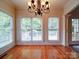 Bright dining room featuring hardwood floors, natural light from large windows, and a stylish chandelier at 2608 Golden Bell Dr, Gastonia, NC 28056