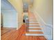 View of the spacious foyer with hardwood floors, stairway, and an arched entryway at 2608 Golden Bell Dr, Gastonia, NC 28056