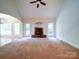 Open living room with a fireplace and natural light from the large windows and French doors at 2608 Golden Bell Dr, Gastonia, NC 28056