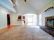 Spacious living room with a fireplace and an arched entryway leading to the kitchen and sunroom at 2608 Golden Bell Dr, Gastonia, NC 28056