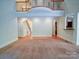 Bright living room boasts an open layout with arched doorways and a wrought iron railing overlooking the space at 2608 Golden Bell Dr, Gastonia, NC 28056