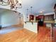 Open-concept living space showcases hardwood floors, a kitchen bar, and dark wood cabinetry at 2608 Golden Bell Dr, Gastonia, NC 28056