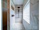 Modern walk-in shower with a rainfall showerhead, handheld sprayer, and stone tile at 2608 Golden Bell Dr, Gastonia, NC 28056