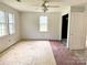 Bright bedroom features ample natural light from large windows and closet with floors ready for renovation at 2791 Neill Rd, Lancaster, SC 29720