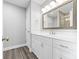 Bathroom with white cabinets, granite countertops, and modern fixtures at 2996 N Lookout St, Claremont, NC 28610
