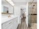 Bright bathroom with glass shower, white cabinets and plank floors at 2996 N Lookout St, Claremont, NC 28610