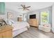 Bedroom featuring neutral tones, natural wood furniture, and plank flooring at 2996 N Lookout St, Claremont, NC 28610