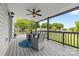 Covered porch with wicker furniture, ceiling fan, and a view of the backyard at 2996 N Lookout St, Claremont, NC 28610