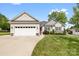Charming single-Gathering home with a two-car garage, landscaped yard, and inviting red front door at 2996 N Lookout St, Claremont, NC 28610