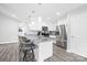 Modern kitchen features stainless appliances, white cabinets, and an island with bar seating at 2996 N Lookout St, Claremont, NC 28610
