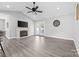 Bright living room features vaulted ceilings, fan, fireplace, and doors to outdoor space at 2996 N Lookout St, Claremont, NC 28610