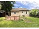 A charming backyard with a garden, a small patio, lush greenery, and a well-maintained lawn at 327 Bonview Ave, Lincolnton, NC 28092
