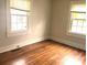 A bright bedroom with hardwood floors and two windows bringing in plenty of natural light at 327 Bonview Ave, Lincolnton, NC 28092