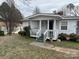 Exterior shot of home's front with porch and landscaping at 341 Talley St, Troutman, NC 28166