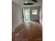 Vacant living room showing ceiling fan and door to back yard at 341 Talley St, Troutman, NC 28166