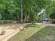 Large backyard with treehouse, basketball court, and wooden deck, perfect for entertaining at 3459 Selwyn Ave, Charlotte, NC 28209