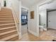 Basement hallway with stairs, view to a recreation area, and a bathroom at 3459 Selwyn Ave, Charlotte, NC 28209