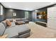 Finished basement with a comfortable seating area, TV, and neutral carpet at 3459 Selwyn Ave, Charlotte, NC 28209