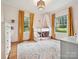 Bright bedroom with a bunk bed, playful decor, large windows, and hardwood floors at 3459 Selwyn Ave, Charlotte, NC 28209