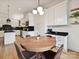 Bright dining area adjacent to kitchen with round table and decorative lighting at 3459 Selwyn Ave, Charlotte, NC 28209
