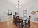 Cozy dining room featuring a farmhouse table, modern light fixture and bright neutral paint colors at 3459 Selwyn Ave, Charlotte, NC 28209