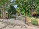 Gated driveway and backyard featuring a treehouse and deck at 3459 Selwyn Ave, Charlotte, NC 28209