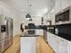 Modern kitchen with stainless steel appliances, white cabinets, and black countertops at 3459 Selwyn Ave, Charlotte, NC 28209