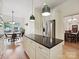 Island kitchen with stainless steel refrigerator. View to a dining area and dining room at 3459 Selwyn Ave, Charlotte, NC 28209