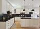 Modern kitchen with white cabinets, black countertops, and stainless steel appliances at 3459 Selwyn Ave, Charlotte, NC 28209