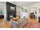 Inviting living room showcasing a black brick fireplace, hardwood floors, and a seamless connection to the dining area at 3459 Selwyn Ave, Charlotte, NC 28209