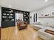 Spacious living room with hardwood floors, built-in bookshelves, and comfortable seating at 3459 Selwyn Ave, Charlotte, NC 28209