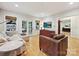 Bright living room with hardwood floors, comfortable seating, and natural light from french doors at 3459 Selwyn Ave, Charlotte, NC 28209