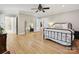 Spacious bedroom with hardwood floors, ceiling fan, large mirror, and ensuite bath at 3459 Selwyn Ave, Charlotte, NC 28209
