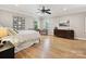 Spacious main bedroom with hardwood floors, natural light, and a ceiling fan at 3459 Selwyn Ave, Charlotte, NC 28209