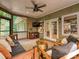 Comfortable screened porch with a ceiling fan, cozy seating, and charming decor at 3459 Selwyn Ave, Charlotte, NC 28209