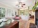 Bright and airy sunroom with built-in shelving, large windows, and a comfortable chair at 3459 Selwyn Ave, Charlotte, NC 28209