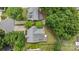 An aerial view of the house with a gray roof, wooden deck, and fenced yard surrounded by mature trees at 3801 Rosedown Dr, Matthews, NC 28105