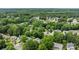 Scenic aerial view of a verdant neighborhood, showcasing a community surrounded by lush greenery and well-kept residences at 3801 Rosedown Dr, Matthews, NC 28105