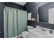 Updated bathroom with dark walls, shower, framed mirror, and white vanity at 3801 Rosedown Dr, Matthews, NC 28105