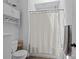 Well-lit bathroom with tile floor, storage cabinet, and shower/tub combo at 3801 Rosedown Dr, Matthews, NC 28105