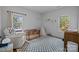Bedroom features hardwood floors, natural light, and a cozy sitting area at 3801 Rosedown Dr, Matthews, NC 28105