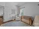 Bedroom features hardwood floors, natural light, and a cozy sitting area at 3801 Rosedown Dr, Matthews, NC 28105