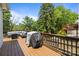 Large wooden deck with outdoor seating, including a grill, perfect for hosting gatherings at 3801 Rosedown Dr, Matthews, NC 28105