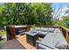 Enjoy the deck with a hot tub and a comfortable outdoor sectional sofa, perfect for entertaining at 3801 Rosedown Dr, Matthews, NC 28105