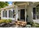 Inviting front entrance featuring a black door, flower pots, and well-maintained landscaping at 3801 Rosedown Dr, Matthews, NC 28105