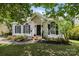 Charming home with a covered porch, black shutters, and lovely landscaping, offering curb appeal and a welcoming entrance at 3801 Rosedown Dr, Matthews, NC 28105