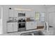 Well-lit kitchen with white cabinets, stainless steel appliances, and granite countertops at 3801 Rosedown Dr, Matthews, NC 28105