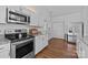 Bright kitchen features stainless steel appliances, granite counters, and hardwood flooring at 3801 Rosedown Dr, Matthews, NC 28105