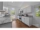 Bright kitchen with white cabinets, granite counters, stainless appliances, and hardwood flooring at 3801 Rosedown Dr, Matthews, NC 28105